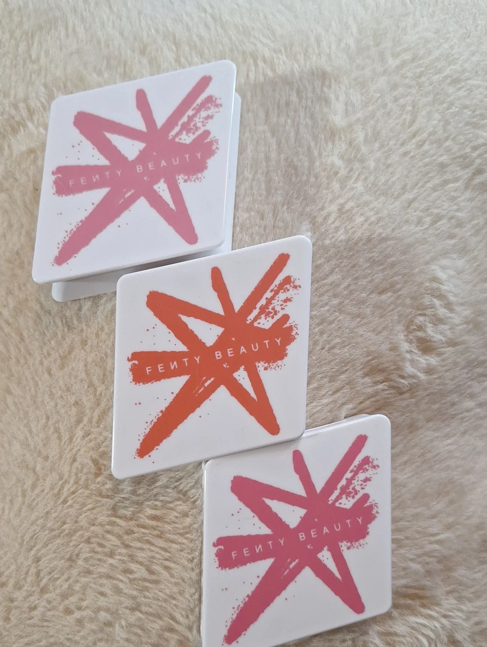 Fenty Beauty White Compacts with Pink & Orange Star Accents